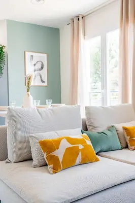 a couch with pillows on it in a living room at Havre de nature Provence in Morières-lès-Avignon