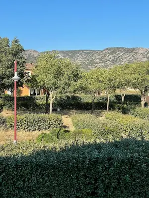a red pole in the middle of a field with trees at La Remise de Guytou et Spa in Cheval-Blanc