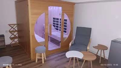 a room with a table and chairs and a mirror at La Remise de Guytou et Spa in Cheval-Blanc