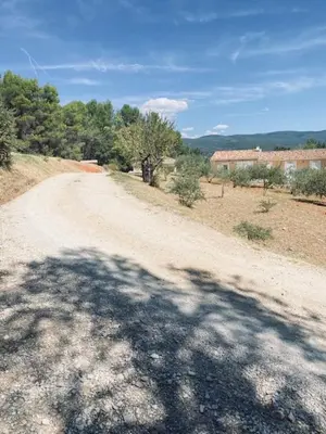 a dirt road with a large shadow on it at Jolie maison de 110 m 2, pour 6 personnes, au calme, avec piscine in Les Cordiers