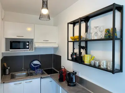 a kitchen with a sink and a microwave at Ma place au sud 1 in Éguilles