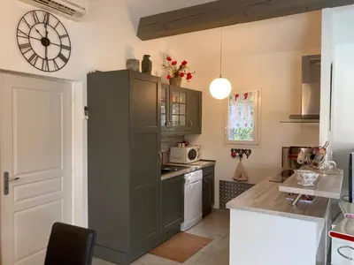 a kitchen with a large gray cabinet and a microwave at Les Hauts d'Eyragues gite Rêverie Meublé classé 4 étoiles in Eyragues