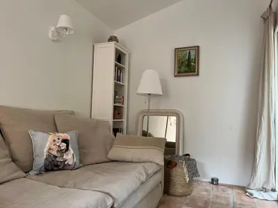 a living room with a couch with a dog pillow on it at Charming village house in Goult in Goult