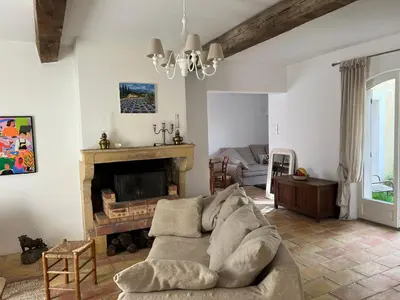 a living room with a couch and a fireplace at Charming village house in Goult in Goult
