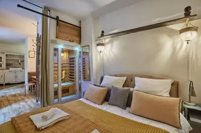 a bedroom with a large bed with white pillows at Appart Aix sauna jacuzzi balneo spa privatifs hyper centre historique cour intérieur in Aix-en-Provence