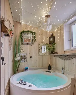 a tub in a bathroom with lights on the ceiling at Appart Aix sauna jacuzzi balneo spa privatifs hyper centre historique cour intérieur in Aix-en-Provence