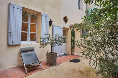 a chair sitting in front of a house at Appart Aix sauna jacuzzi balneo spa privatifs hyper centre historique cour intérieur in Aix-en-Provence
