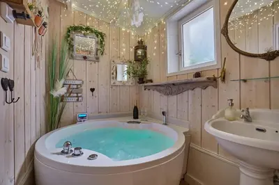 a bathroom with a tub and a sink at Appart Aix sauna jacuzzi balneo spa privatifs hyper centre historique cour intérieur in Aix-en-Provence