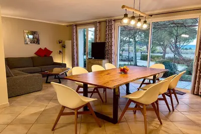 a dining room with a wooden table and chairs at Villa avec Piscine et Vues Imprenables in Villars