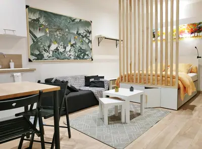 a living room with a couch and a table at Joli studio au calme, centre historique de Pertuis in Pertuis