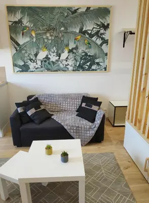 a living room with a couch and a table at Joli studio au calme, centre historique de Pertuis in Pertuis
