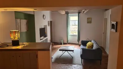 a living room with a couch and a table at Cocon du Papillon à Lourmarin in Lourmarin