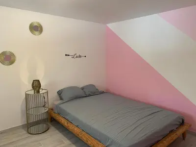 a bedroom with a bed in a room at Ravissant logement avec jacuzzi in Lançon-Provence