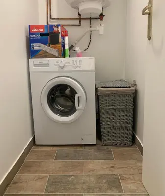 a washer and dryer in a small laundry room at Ravissant logement avec jacuzzi in Lançon-Provence