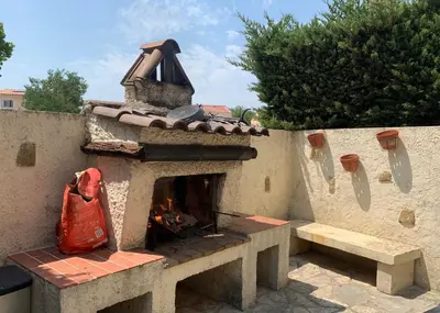 a stone fireplace with a red bag on a wall at Ravissant logement avec jacuzzi in Lançon-Provence