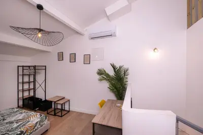 a living room with a couch and a table at Le Nostradamus - Magnifique appartement cours principal plein centre avec parking in Salon-de-Provence
