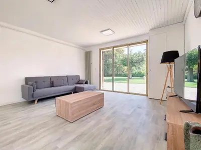 a living room with a couch and a tv at Gites Partage des Eaux L'isle sur la Sorgue in LʼIsle-sur-la-Sorgue