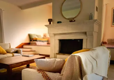 a living room with a couch and a fireplace at La Villa La Source à Aix en Provence in Aix-en-Provence