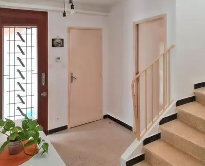 an empty hallway with stairs and a door at Maison charmante à Monteux avec jardin et équipements complets in Monteux