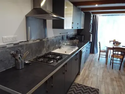 a kitchen with a sink and a stove top oven at Gîte de Fanny du Moulin de Tartay en Avignon in Avignon