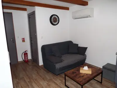 a living room with a couch and a table at Gîte de Fanny du Moulin de Tartay en Avignon in Avignon