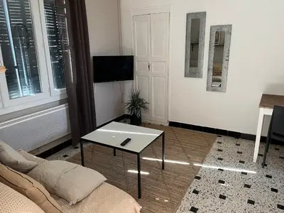 a living room with a couch and a table at Gîte de la bastide in Monteux