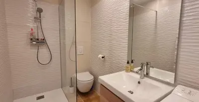 a bathroom with a toilet and a sink and a shower at Les toits de Mignet in Aix-en-Provence