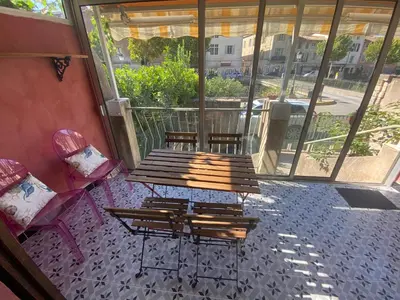 a patio with a wooden bench and two chairs at Maison, Centre-ville, 6 lits, terrasse & parking in Apt