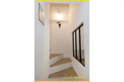 a staircase in a home with white walls and a stair case at Le Craponne - Magnifique appartement cours principal plein centre avec parking in Salon-de-Provence
