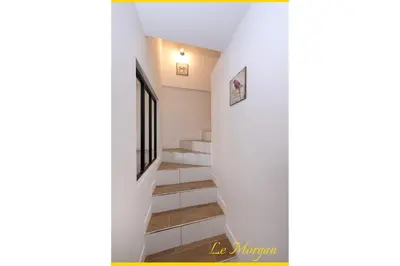 a staircase in a house with white walls and wooden floors at Le Morgan - Magnifique appartement cours principal plein centre avec parking in Salon-de-Provence