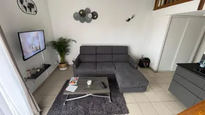 a living room with a couch and a table at Addis in Salon-de-Provence