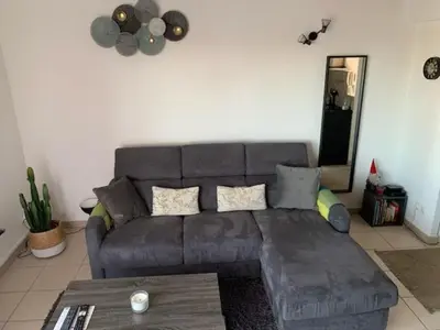 a living room with a gray couch and a table at Addis in Salon-de-Provence