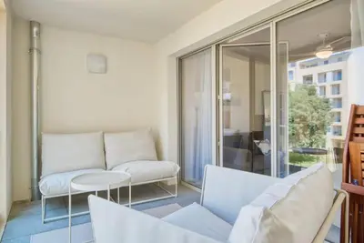 a living room with a couch and a table at Le Fonction, meublé 4 étoiles, avec parking boxé in Aix-en-Provence