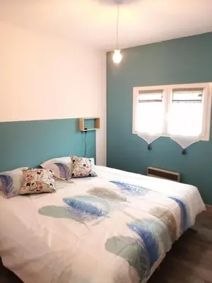a bedroom with a large bed with two pillows at Gite à la campagne à 15 kms d'Aix in Saint-Cannat