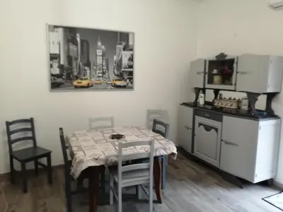 a kitchen with a table with chairs and a refrigerator at Gite à la campagne à 15 kms d'Aix in Saint-Cannat