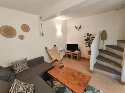 a living room with a couch and a table at Maison de ville au coeur du centre historique, parking gratuit in Apt