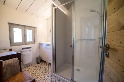 a bathroom with a shower with a glass door at Domaine Les Perpetus in La Tour-dʼAigues