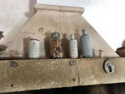 a shelf with glass bottles and peanuts on it at very pleasant provençal mas, typical to the region, with heated pool in saint remy de provence - 9 people in Saint-Rémy-de-Provence