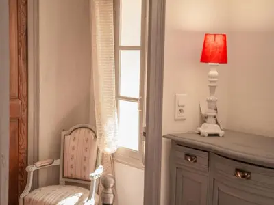 a room with a window and a chair and a lamp at Villa Martinet in Carpentras