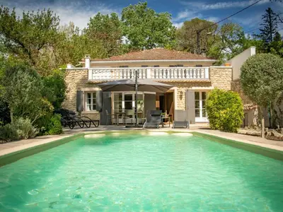 a house with a swimming pool in front of a house at Villa Martinet in Carpentras