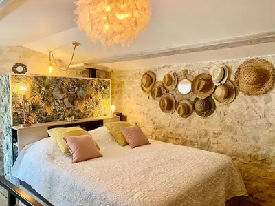 a bedroom with a bed with hats on the wall at Maisonnette atypique cadarache-iter in Saint-Paul-lez-Durance