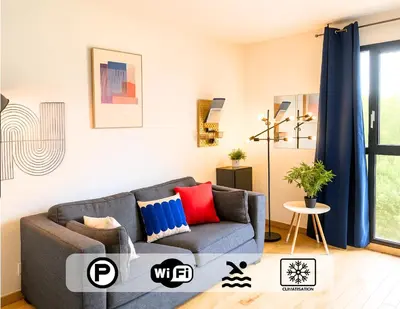 a living room with a gray couch with red and blue pillows at Ma place au sud Aix Parking in Aix-en-Provence