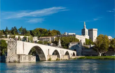 a bridge over a river with a castle in the background at 3 Bedroom Amazing Home In Montfavet in Montfavet