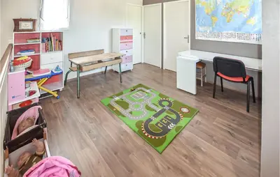 a classroom with a desk and a table and a chair at Gorgeous Home In Puget in Puget