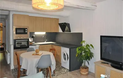 a kitchen with a table and a dining room at Awesome Apartment In Rustrel in Rustrel
