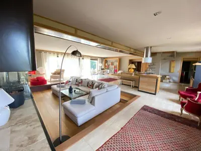 a living room with a white couch and a red rug at Sérénité en Provence, Climatisée in La Roque-sur-Pernes