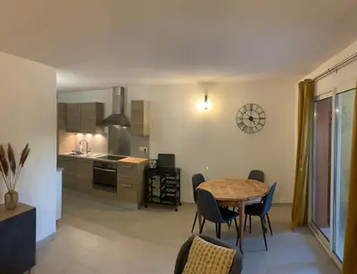a kitchen and dining room with a table and chairs at la pinède in Roussillon