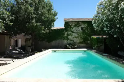 a swimming pool in front of a house at charming provencal house with private pool for 4 people in cheval blanc, luberon. in Cheval-Blanc