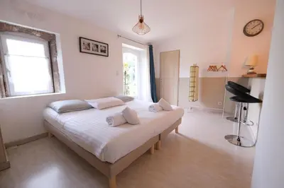a bedroom with a bed with white sheets and a window at charming provencal house with private pool for 4 people in cheval blanc, luberon. in Cheval-Blanc