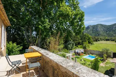 a house with a retaining wall and a pool at Errances Provençales in Saint-Rémy-de-Provence